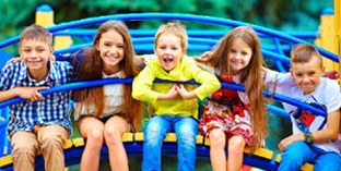 Children sitting together on a playground bridge, brightened